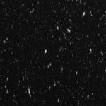 a black and white photo of snow falling