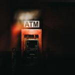 a building with a atm sign lit up at night