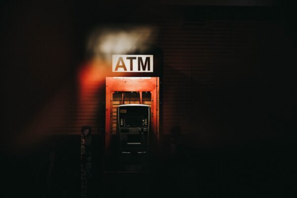a building with a atm sign lit up at night