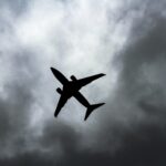 passenger plane under white clouds