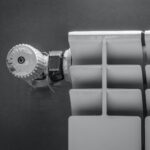 silver round coin on white plastic case