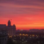 a sunset view of a city with a red sky