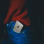 gold iPhone 6 on person's pocket