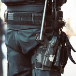 a man holding a gun and a gun holster